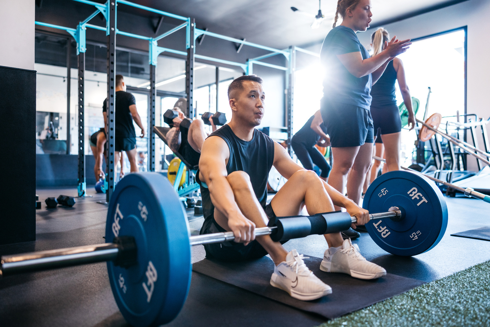 Group session attendee taking a break during a lifting training session