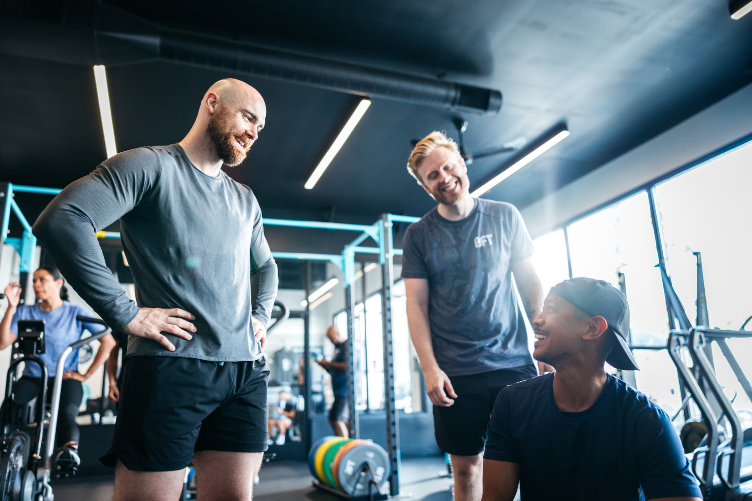 Group of smiling male attendees at a Body Fit Training studio