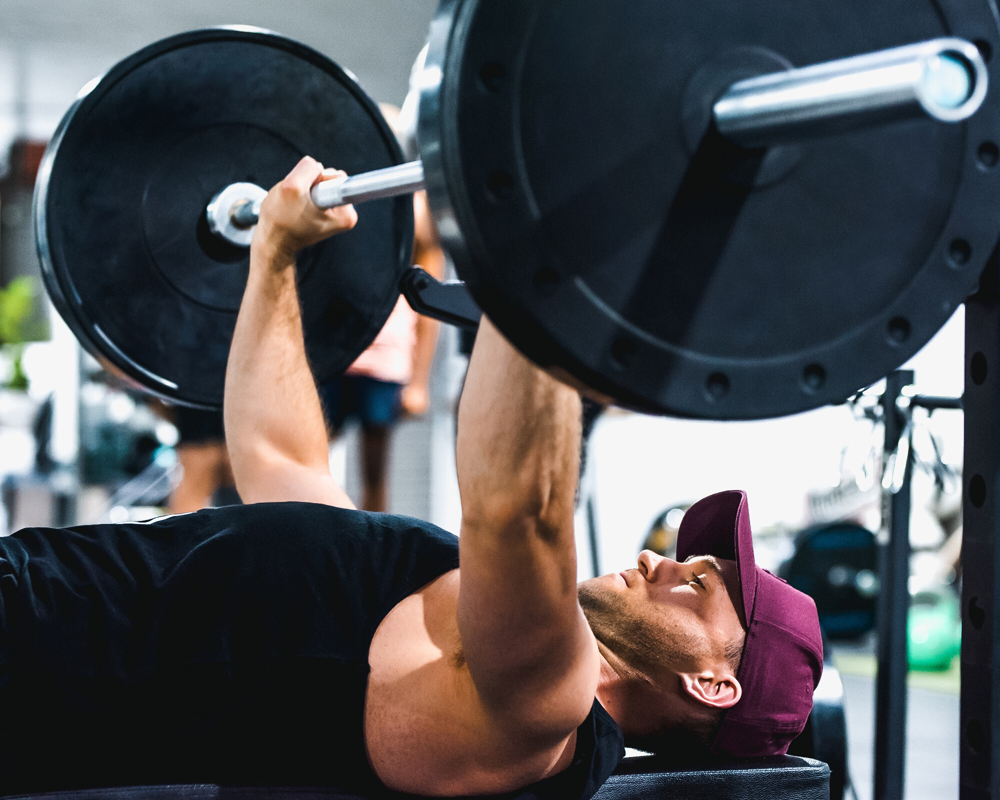 Male weight session attendee demonstrating a bench press at a Body Fit Training studio